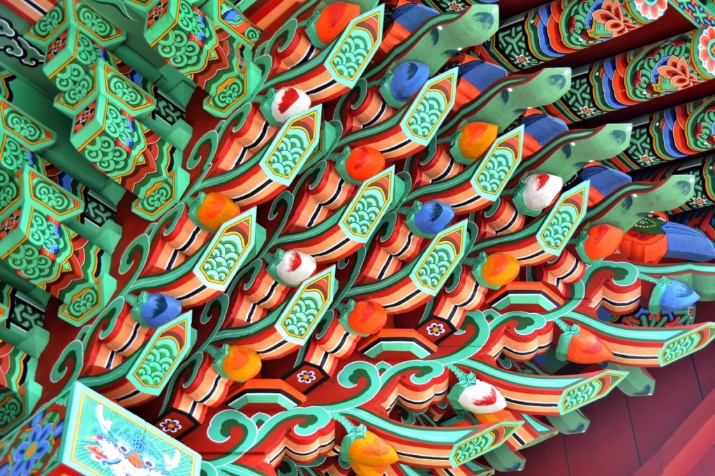 Colorful dancheong patterns decorate the eaves of a traditional Korean temple.
