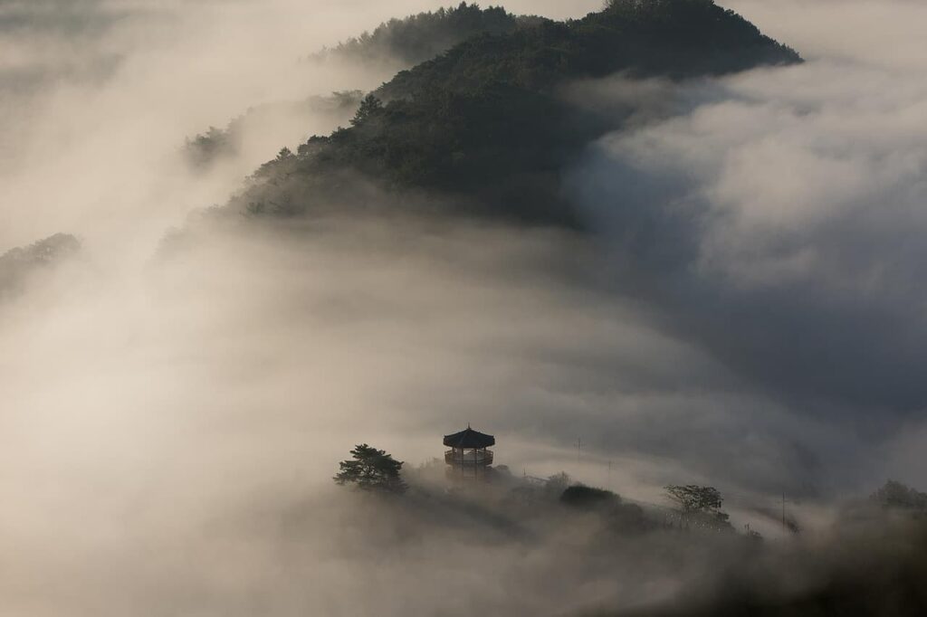 Pavilion on a mountain peak filled with mist