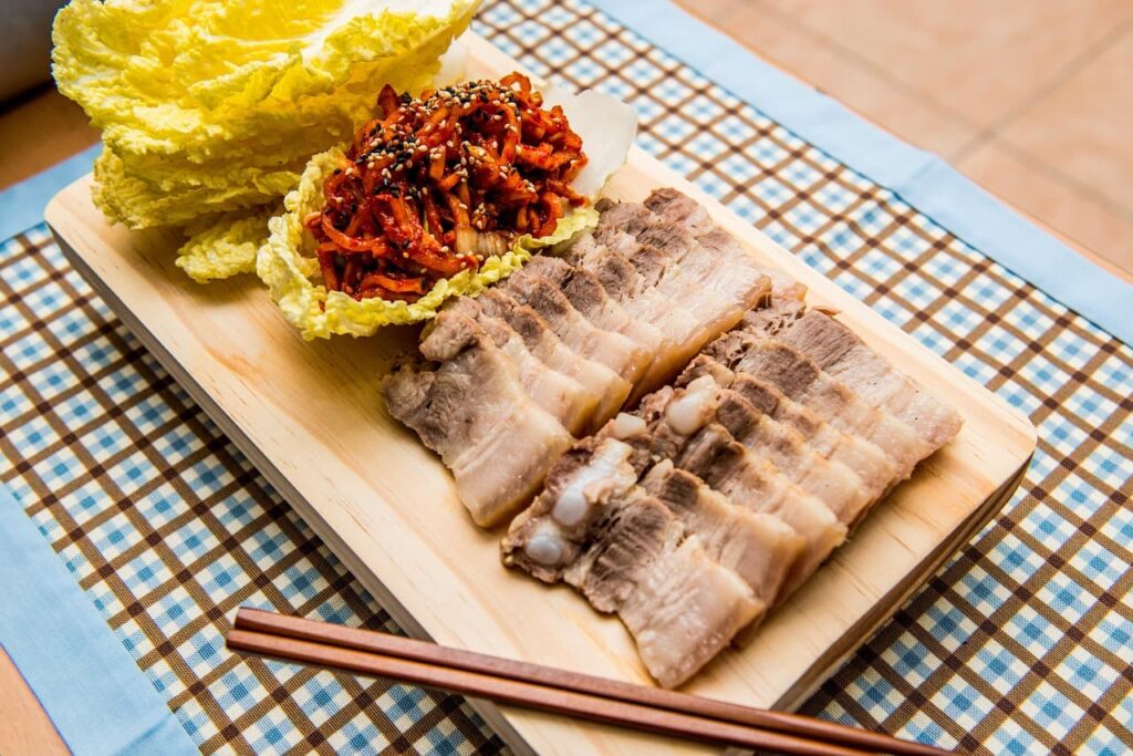 boiled-pork-bossam-kimchi-napa-cabbage-chopsticks
