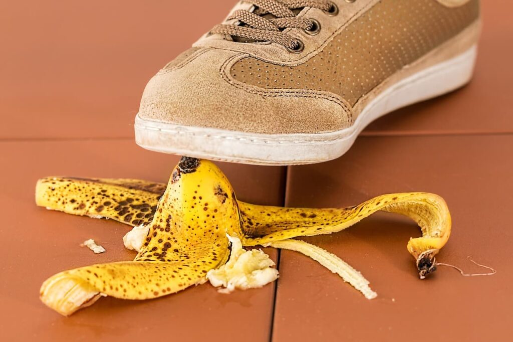 One foot about to step on a banana peel.