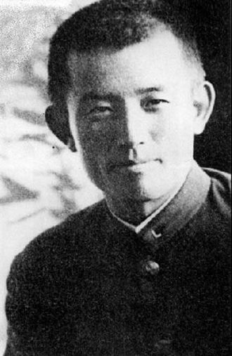 Black-and-white photograph of poet Yun Dong-ju wearing a school uniform with his hair cut short